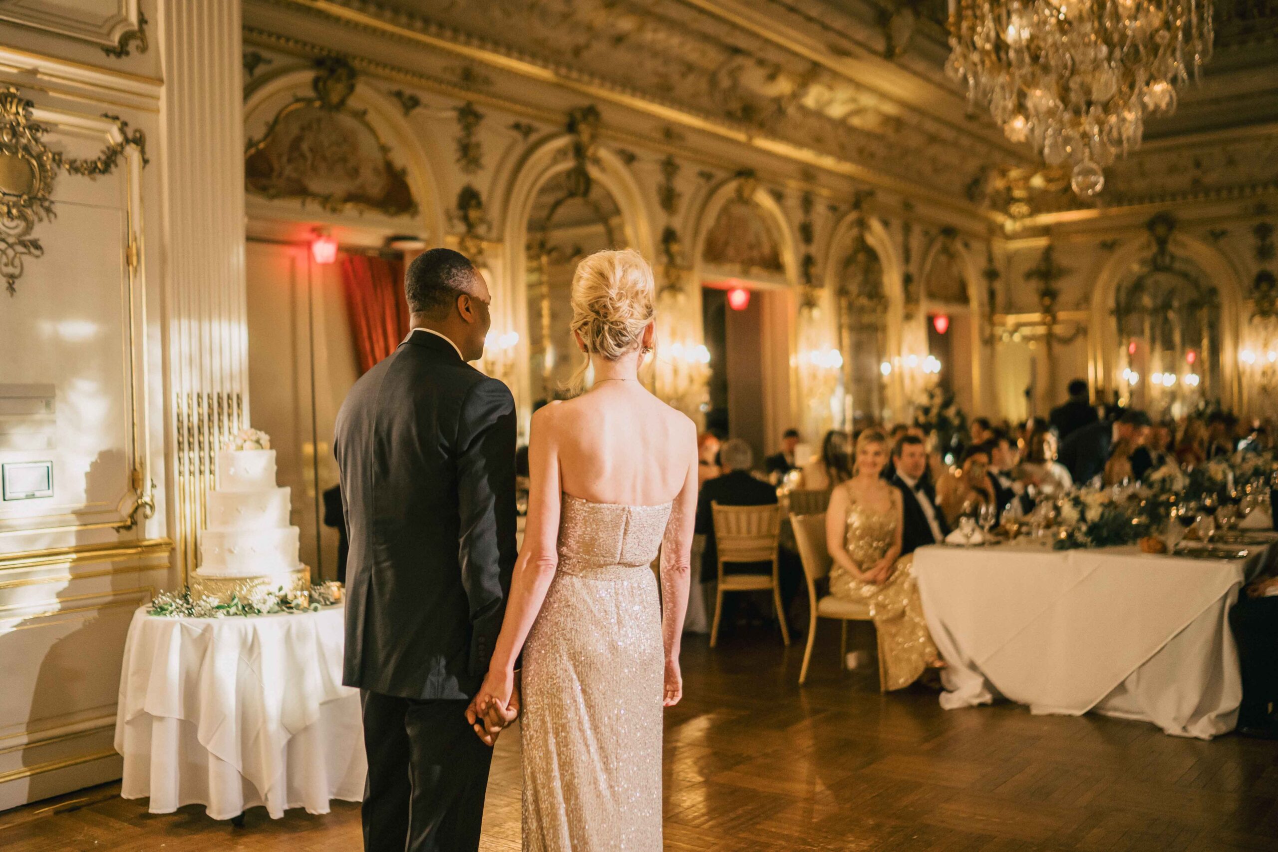 couple stand in front of their wedding guests at the ball room in the Cosmos club in Washington D.C.