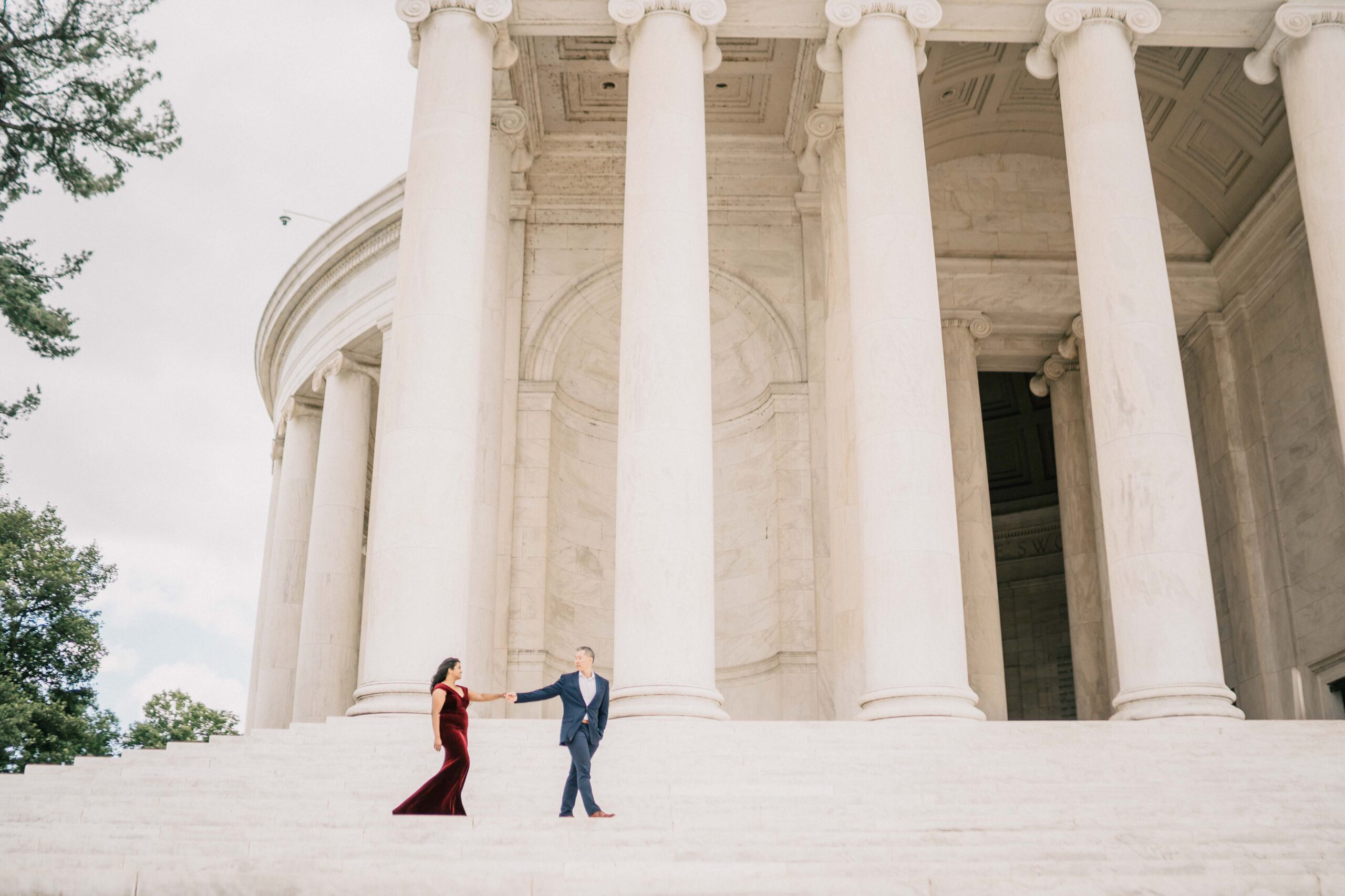 couple hold hand walking on the stairs at Thomas Jefferson Memorial in Washington D.C.