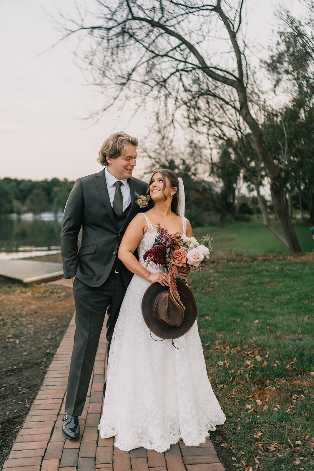 kent island resort wedding cover image couple standing on a path looking at each other with love